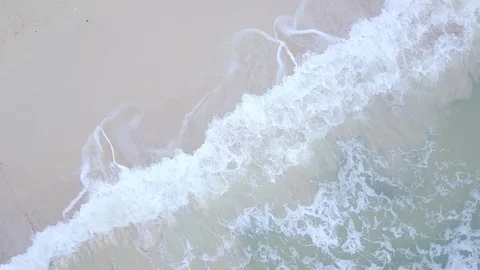 Aerial top view drone footage of ocean waves reaching shore, 4k. Stock Footage