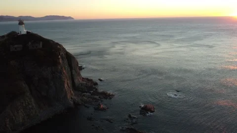 Aerial Top View A Drone Of Lighthouse In Sunshine on Cape Bryner, 4K 動画素材 220533635