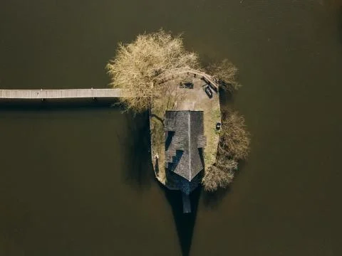 Aerial top view with drone Old house on a forest lake Stock Photos