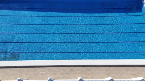 Aerial top view of empty outdoor swimming pool on sunny day 스톡 동영상 340336346
