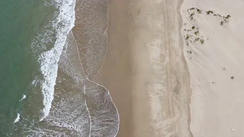 Aerial top view of the foamy waves washi... | Stock Video | Pond5