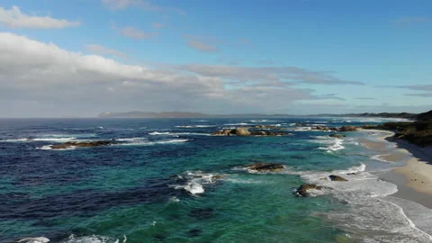 Aerial top view footage of waves breaking on beach and rock, beautiful seascape. Stock Footage 160192011