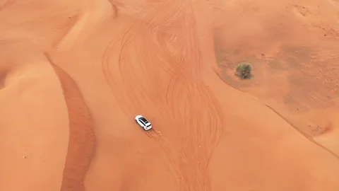 AERIAL. Top view of Four-wheel-drive car in the desert. Stock Footage 109436985