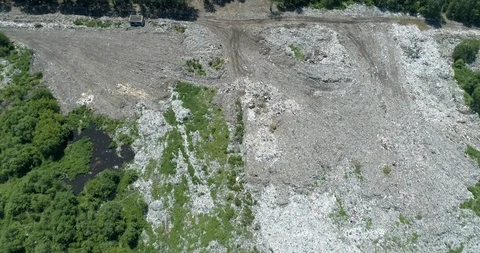 Aerial top view of garbage dump in the middle of the green forest. Ecological Stock Footage 124246398