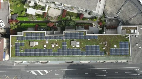 Aerial Top View of Green Roof with Solar Panels on Modern Urban Building Video stock 332828341