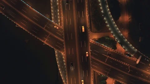Aerial top view of highway interchange at night. Aerial top view of road Stock Footage
