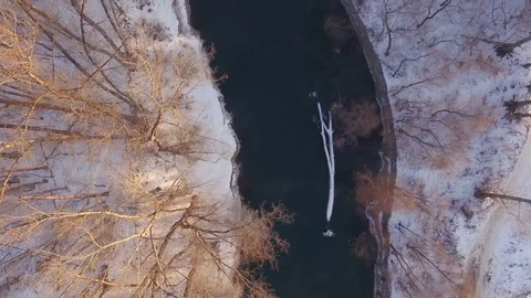 AERIAL: Top view of hot spring among frozen forest during winter season. Video stock 83891297