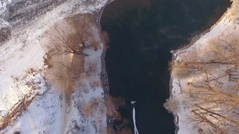 AERIAL: Top view of hot spring among frozen forest during winter season. Stock Footage 83892538