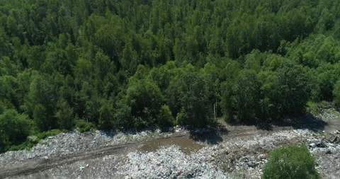 Aerial top view of Illegal garbage dump in the middle of the green forest Stock Footage 144370470