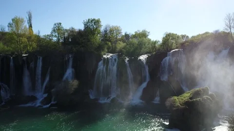 Aerial top view of an impressive waterfall in the background Stock Footage 74494388