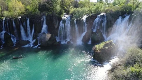 Aerial top view of an impressive waterfall in the background Stock Footage 74494424