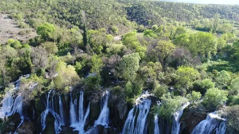 Aerial top view of an impressive waterfall in the background Stock Footage 74539774