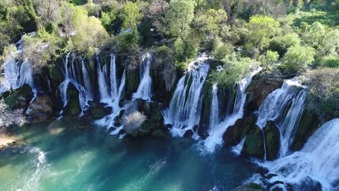 Aerial top view of an impressive waterfall in the background Stock Footage 74542642