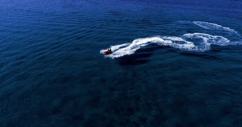 Aerial - Top view of jet ski racing on a crystal clear water. summer vacation Stock Footage 115248997