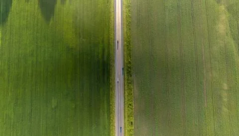 Aerial top view of a landscape while traveling by car on an asphalt highway i Stock Photos