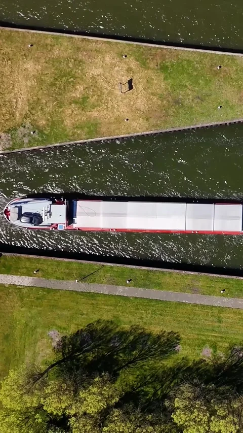 Aerial Top View Of Large Cargo Barge Navigating Canal Stock Footage 335476156