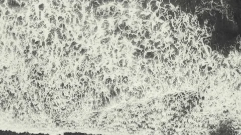 Aerial top view of large waves rolling over after eachother Stock Footage 146753689