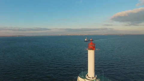 Aerial top view of a lighthouse in the blue sea. View from above. Video stock 129615957