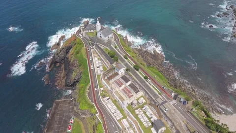 Aerial top view of lighthouse buildings above wave washed rocks Stockbeeldmateriaal 343325224