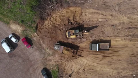 Aerial top view: loaded tipper with soil moving reverse to pour out ground Stock Footage 130978257