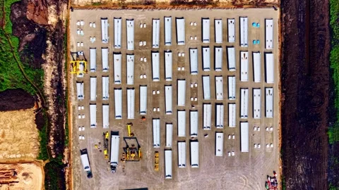 Aerial top view of long rectangular frames on ground beside and industry during Stock Footage 315279403