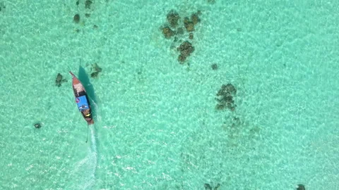 Aerial top view of long-tailed boat is sail on the emerald sea. Andaman sea Stock Footage 203386403