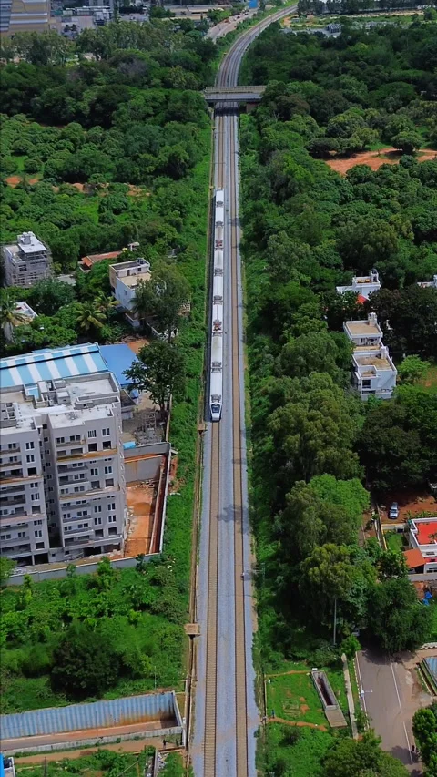Aerial Top View Of Metro Train Running On Track Through city " vande bharat " Video stock 344458838