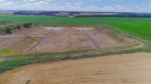Aerial top view. New empty garbage dump among green field Stock Footage 273208512