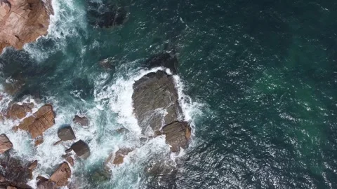 Aerial top view of ocean wave splashing on rocks, nature dynamism Stock Footage 241049242