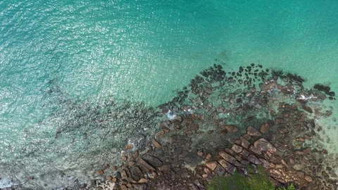 Aerial top view of ocean waves, beach and rocky coastline and beautiful forest.  Stock Footage 108268708