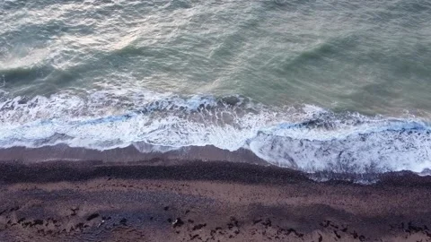 Aerial top view of ocean waves break on a beach. Sea waves and sand beach aerial Stock-Footage 144182241
