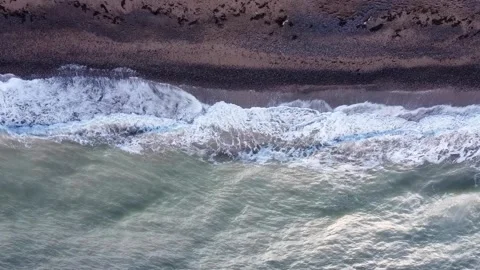 Aerial top view of ocean waves break on a beach. Sea waves and sand beach aerial Stock-Footage 147149130