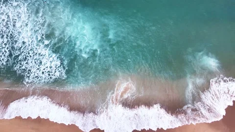 Aerial Top View of Ocean Waves Reaching Beach Shore. Drone Footage. Stock Footage