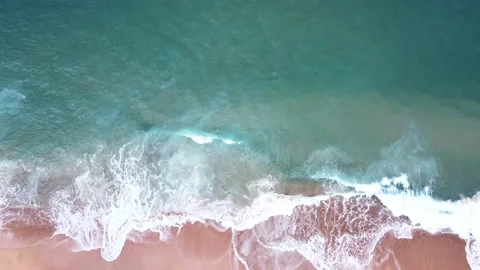 Aerial Top View of Ocean Waves Reaching Beach Shore. Drone Footage with no Stock Footage 154227211