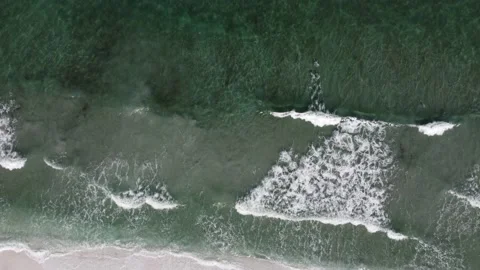 Aerial Top View Of Ocean Waves Reaching Beach Shore. Drone Footage. Stock Footage 225858860