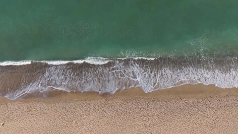 Aerial top view of ocean waves crashing on sandy beach Stock Footage 320790796