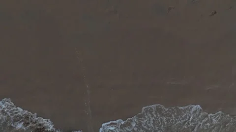 Aerial Top View of Ocean Waves Crashing on Sandy Beach with Rocks Stock Footage 331863872