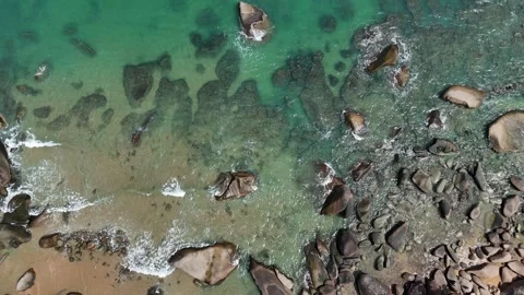 Aerial Top View of Ocean Waves Crashing on Sandy Beach with Rocks Stock Footage 331864319