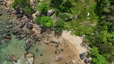 Aerial Top View of Ocean Waves Crashing on Sandy Beach with Rocks Stock Footage 331864920