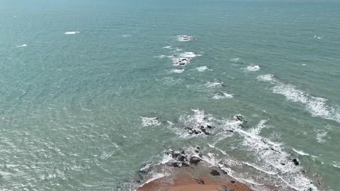 Aerial Top View of Ocean Waves Crashing on Sandy Beach with Rocks Stock Footage 331865574