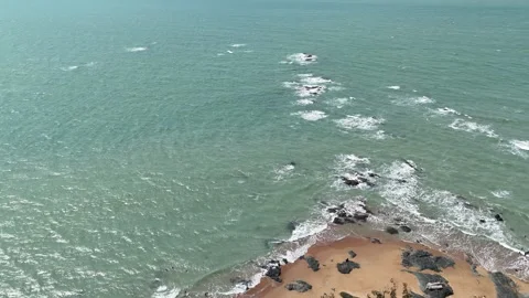 Aerial Top View of Ocean Waves Crashing on Sandy Beach with Rocks Stock Footage 331865575