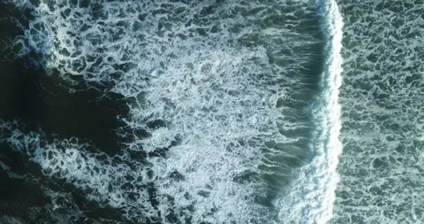 Aerial top view of ocean waves and a sandy beach The Concept of nature and .. Stock Footage 335738466