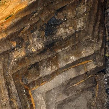 Aerial top view of an open pit coal mine featuring layered earth textures, .. Stock Photos