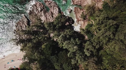 Aerial Top view over beach, ocean waves crashing on rocks and sand. Stock Footage 200837524