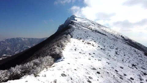 Aerial Top View Over Cloudy Rocky Snowy Mountain In Sunny Day Stock Footage 317049973