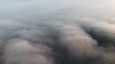 Aerial top view over the fog, in the Romanian countryside	 Stock Footage 234419082