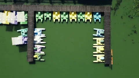 Aerial top view of parked multi-colored catamarans in a row on the pier Stock Footage 139200069