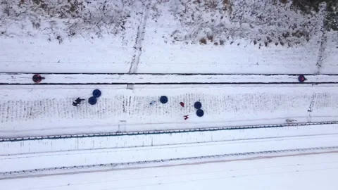 Aerial top view of people pulling up to hill top on snow tubes Stock Footage 148568663