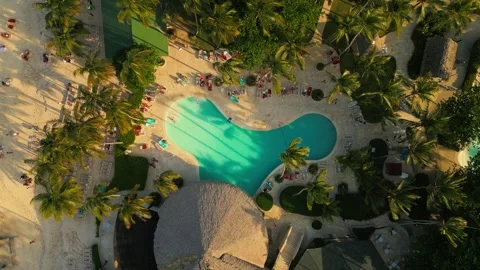 Aerial top view of pool. Sunset warm, light over everything. Tourists relaxing Stock Footage 305556663