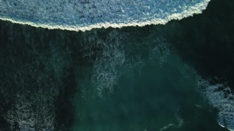 Aerial top view of powerful dark ocean waves crashing with white foam Stock Footage 305387975